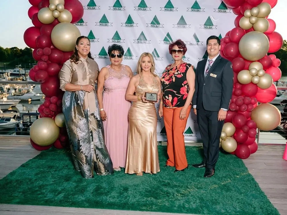 An award recipient with NSLBA members on the waterfront at a past Gala