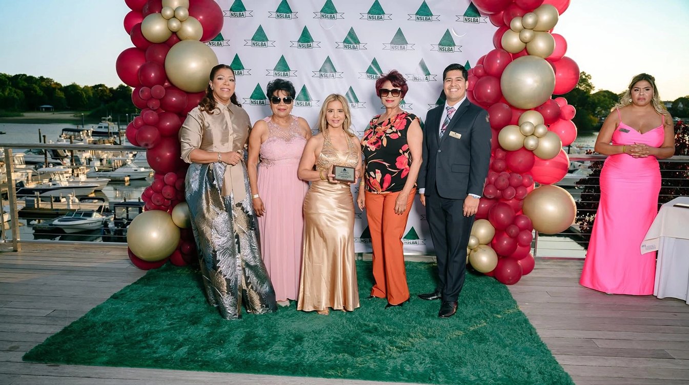 An award recipient with guests at the waterfront reception
