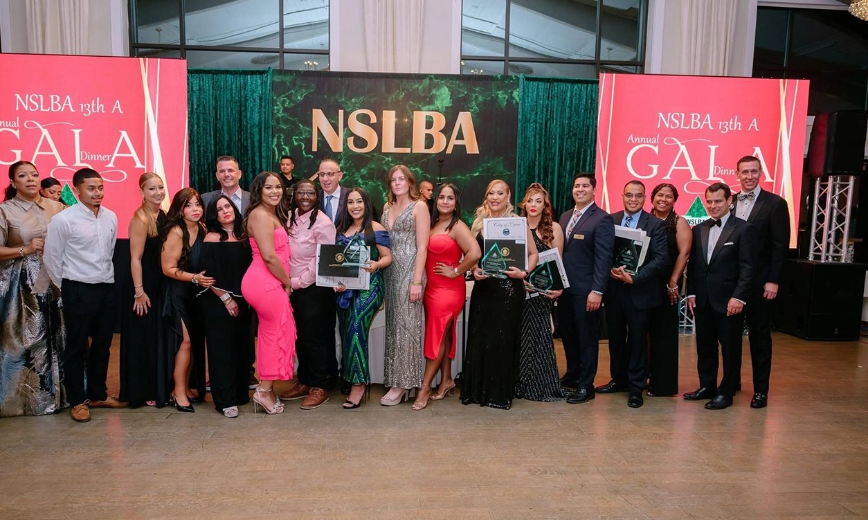 Award recipients and guests on stage at a past NSLBA Gala
